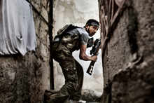 A Free Syrian Army fighter takes up a position during clashes against Government forces. Photo / Fabio Bucciarelli, AFP