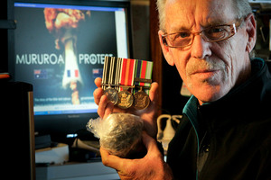 NZ Navy veteran Wayne O'Donnell shows his navy medals and half of a cancerous tumour taken out of his body. Photo / Warren Buckland