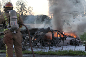 A car smashed a power pole and burst into flames on Te Aute Rd, Pakipaki. Photo / Duncan Brown