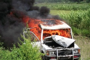 A vehicle set alight by demonstrators protesting the deaths of schoolchildren at a school in the Saran district of Bihar state. Photo / AFP