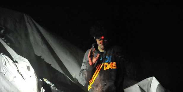 Police tactical photographer Sgt. Sean Murphy took this shot of a downcast Tsarnaev with the red dot of a sniper's rifle laser sight on his forehead.