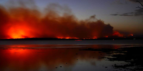 In this photo provided by the New South Wales Rural Fire Service a fire burns near Sussex Inlet, Australia. Photo / AP