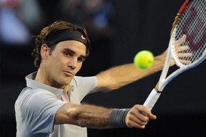 Switzerland's Roger Federer makes a backhand return to Russia's Nikolay Davydenko during their second round match at the Australian Open tennis championship. Photo / AP