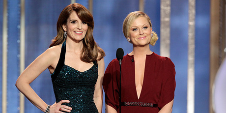 Tina Fey, left, and Amy Poehler deliver their opening monologue. Photo/AP