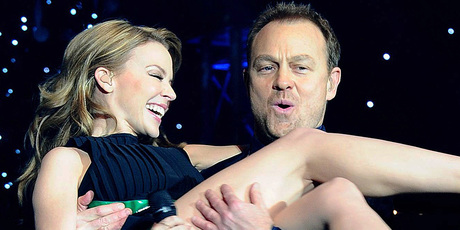 Kylie Minogue in the arms of Jason Donovan during a Christmas performance. Photo/AP