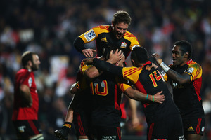 The Chiefs celebrate last night's slim victory over the Crusaders. Photo / Getty Images