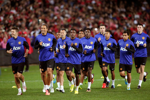 Manchester United players warm up in front of a 22,000 strong crowd during training in Sydney, Australia, Friday, July 19, 2013. Photo / AP.