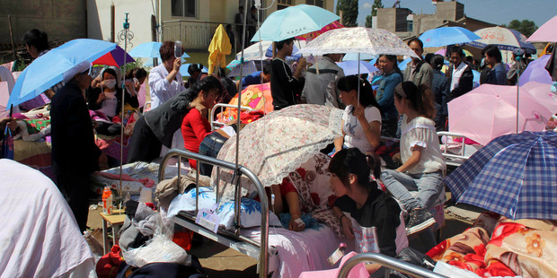 Residents gather at a makeshift on the grounds of a hospital for medical services after an earthquake hit Minxian county in northwest China's Gansu province.Photo / AP