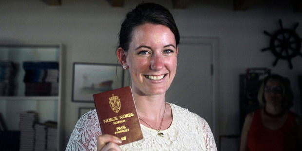 Norwegian Marte Deborah Dalelv, 24, shows her passport - her ticket to leave a country which jailed her over a rape claim. Photo / AP