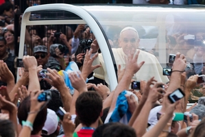 People reach out to Pope Francis as he arrives in Rio at a tense time for Brazil. Photo / AP