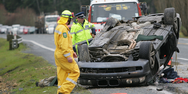 Two fortunate passengers walked away unscathed after this car overturned near Hukerenui yesterday. Photo / Ron Burgin