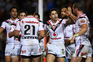 Shaun Johnson of the Warriors celebrates with team mates after scoring the Warrior's opening try. Photo / Getty Images
