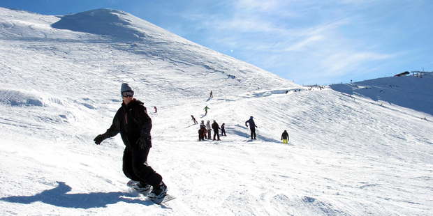 A day's snowboarding is made perfect by a slice from Hutt Pizza. Photo / Doug Sherring