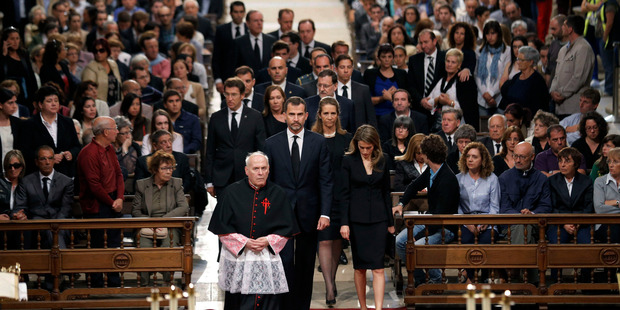Prince Felipe, centre and Princess Letizia front right arrive with members of the Spanish government for a funeral mass at the cathedral in Santiago de Compostela, Spain. Photo / AP