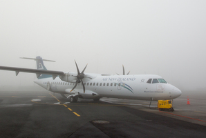 An Air New Zealand Link plane sits on the tarmac in thick fog. File photo / NZ Herald