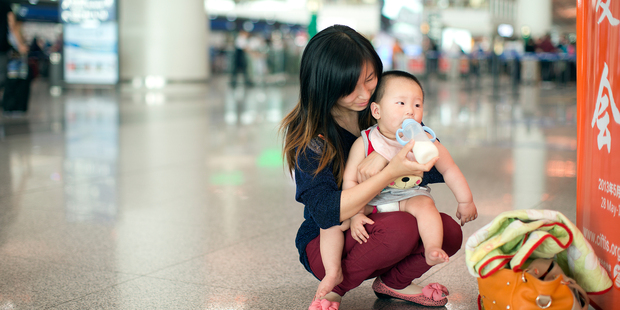 A Chinese mother feed her baby at a shopping mall in Beijing. The reputation of NZ dairy produce is getting a battering in the Chinese media. Photo / David White.