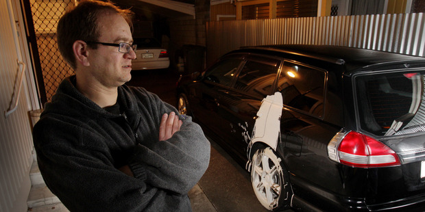 Hastings man Anthony Manley with his vandalised sedan. Photo / Warren Buckland.