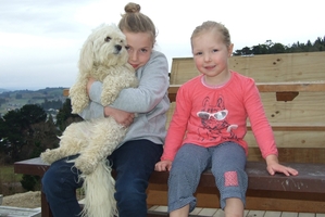 Charli, 8, (with dog Daisy) and Meg, 4, have ataxia, which affects their balance. Photo / Otago Daily Times