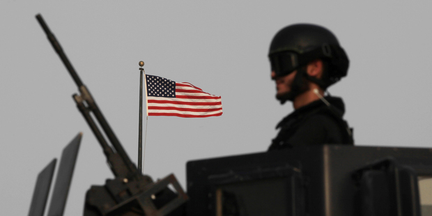 A Bahraini armoured personnel vehicle reinforces U.S. Embassy security just outside a gate to the embassy building in Manama, Bahrain. Photo / AP