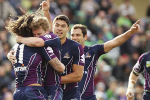 Storm players congratulate Kevin Proctor after scoring a try during the round 21 NRL match between the Canberra Raiders and the Melbourne Storm. Photo / Getty Images.