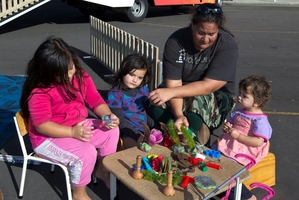 Rickina Walker and her children, Justice, 6, Liberty, 4, and Trinity, 2, spend some time at the Play Truck. Photo / Brett Phibbs