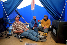 Andrew Johnston (right) of 3 Clifford St, with neighbours David and Susanne Carrick of number 1, in his tent. Photo / Tim Cuff