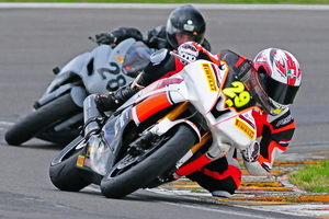 Rangiora's Jake Lewis (pictured left racing in New Zealand) is now making an impact overseas. Pictures / Andy McGechan, BikesportNZ.com
