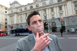 John Weekes gauges reactions to his e-cigarette at Britomart. Photo / Doug Sherring