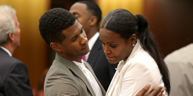 Singer Usher Raymond IV talks with his ex-wife Tameka Raymond after the judge ruled in Usher's favor keeping custody of their two sons. Photo / AP