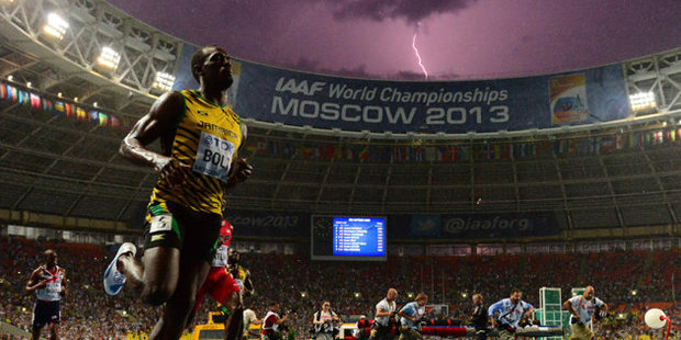 French photographer Olivier Morin manages to capture a lightning bolt as Usain Bolt won the 100m in Moscow. Photo / AFP