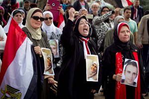 Naylaa El-Hakim, Nawal El-Beih and Nahla Yazal from the Auckland Egyption community hold photos of people who have been killed in the protests in Egypt. Photo / Chris Gorman