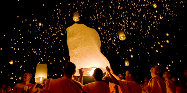 Buddhist monks releasing lanterns during Yi Peng Sansai Kathina Ceremony. Photo / Lonely Planet Images