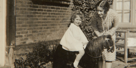 Previously unpublished family photograph issued by the Royal Collection of Britain's Queen Elizabeth II with her mother Elizabeth Bowes-Lyon and a toy horse in front of Naseby.Photo / AP