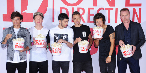 One Direction, from left to right, Louis Tomlinson, Niall Horan, Zayn Malik, Liam Payne and Harry Styles with documentary filmmaker Morgan Spurlock. Photo / AP