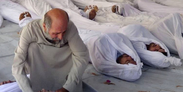 In this citizen journalism image, a Syrian man mourns over a dead body after the alleged gas attack in Damascus. Photo / AP