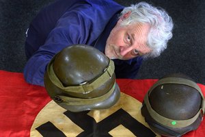 Hayward's Auction House co-proprietor Kevin Hayward shows some of the Nazi memorabilia being sold in Dunedin. Photo / Peter McIntosh