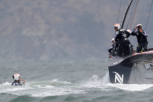 Team NZ skipper Dean Barker looks on as Rob Waddell surfaces. Photo / AP