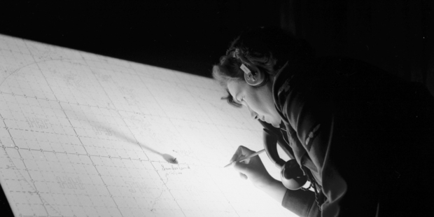 A Women's Auxiliary Air Force member plots a position on the map.