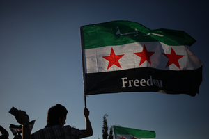 A Syrian protester waves the Syrian revolutionary flag. Photo / AP