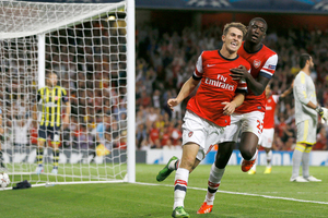 Arsenal's Aaron Ramsey, left, celebrates his second goal against Fenerbahce with teammate Yaya Sanogo during their Champions League qualifying play-off second leg soccer match. Photo / AP