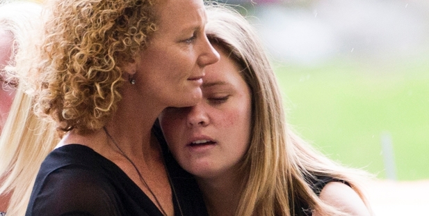 Nicola Waite, former wife of Trevor Waite, comforts her daughter Kelsey at the funeral. Kelsey discovered the bodies. Photo / Greg Bowker