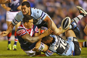 Sonny Bill Williams of the Roosters offloads during his side's defeat to the Sharks. Photo / Getty Images