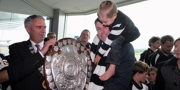 Simon Tremain and son Kalle joined Hastings Mayor Lawrence Yule in hoisting the shield aloft - as did all who got close to it when it arrived yesterday. Photo / Duncan Brown