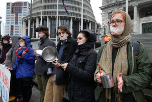 Protesters create a racket with pots and pans outside Parliament yesterday. Photo / Mark Mitchell