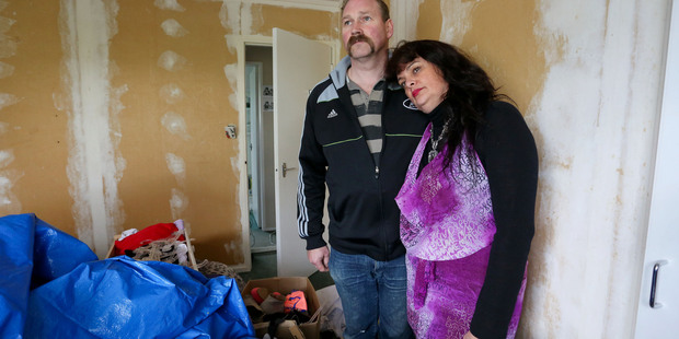 Karen and Scott Odell pose in their daughters' bedroom, which was contaminated by toxic paint during renovations in Whitby, Wellington. Photo / Hagen Hopkins