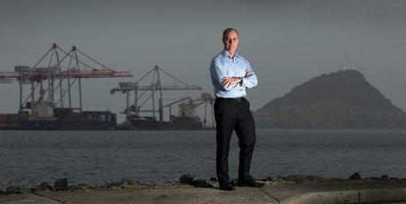Andrew Coker, standing in front of the Port of Tauranga, says the Bay of Plenty and Waikato will benefit from Auckland growth. Photo / Alan Gibson