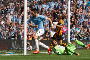 Manchester City's Alvaro Negredo, centre, wheels away to celebrate after scoring past Hull's goalkeeper Allan McGregor, bottom right, during their English Premier League soccer match. Photo / AP