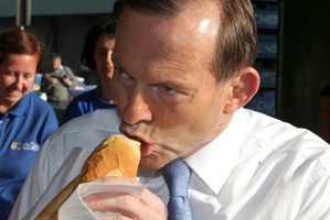 Liberal leader Tony Abbott has plenty to chew over as he meets the voters in Sydney yesterday. Photo / AP