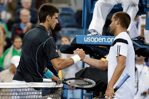 Novak Djokovic, Serbia, is congratulated by Mikhail Youzhny, Russia, after Djokovic defeated Youzhny in a quarterfinal match at the 2013 U.S. Open tennis tournament. Photo / AP.