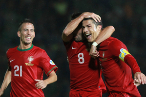 Portugal's Cristiano Ronaldo, right, reacts with Joao Moutinho, center, and Joa Periera after scoring a goal against Northern Ireland during their World Cup Group F qualifier. Photo / AP